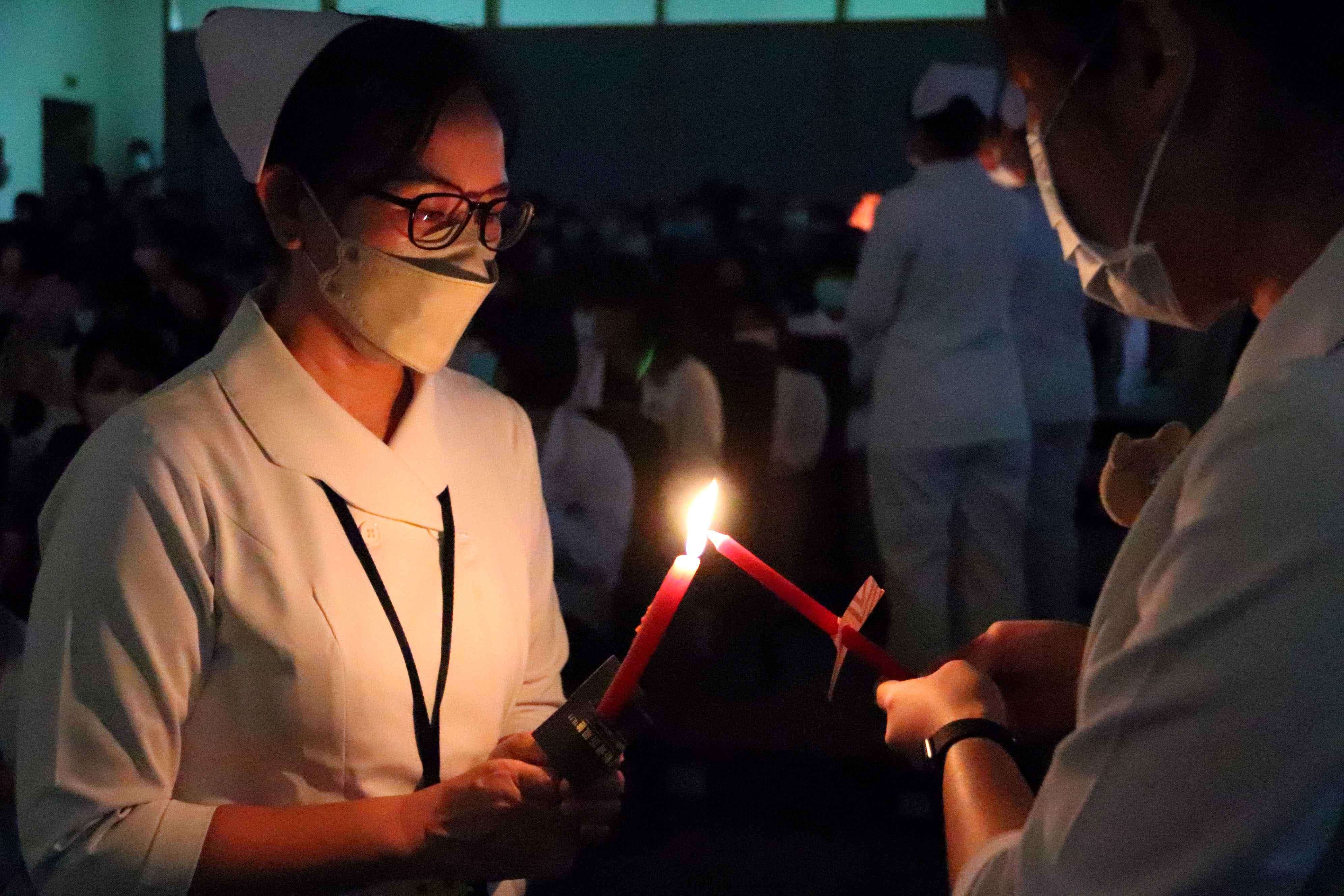台東基督教醫院國際護師節感恩禮拜，與會的護理師們傳遞燭光，象徵南丁格爾精神與理念的傳承。